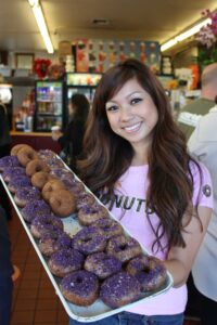 Mayly Tao poses with her latest creation, donuts made with the ube root, a bright lavender yam. (Michael 'Snacks' Ryan michael@www.smdp.com)