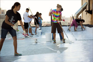 AT WORK: Some 90 percent of U.S. buildings have dark-colored roofs which, when exposed to full sun can increase in temperature by as much as 90 ¬∞F. A white roof typically increases temperatures only 10-25 ¬∞F above ambient air temperatures during the day. (Photo courtesy White Roof Project)