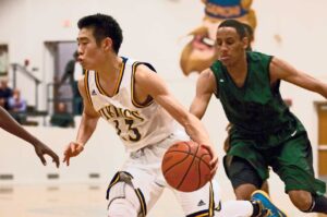 MAIN MAN: Santa Monica's Travis Fujita (center) dribbles past Inglewood defenders on Wednesday at home.  (Morgan Genser editor@www.smdp.com)