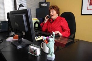 WORKING THE PHONES: CEO Elaine Lazar at the office doing what she does best. (Photo courtesy Eugene Groisman)