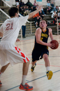 GOING STRONG: Samohi's Ray Mancini tries to drive past Beverly Hills' Ronan Massana (left) on Wednesday. Beverly Hills went on to win the Ocean League game, 55-47. (Morgan Genser editor@www.smdp.com)