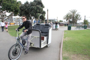 NEED A LIFT? Jason Arbogast and Ray Martinez, owners of Pedicab-It, out on the corner of Ocean and Colorado avenues looking for customers who need a ride. The city by the sea is now home to seven pedicab companies, 40 registered vehicles, and 56 drivers, according to a recent report from City Hall. (David Mark Simpson dave@www.smdp.com)