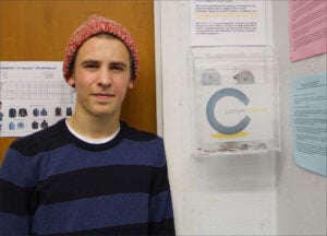 Justin Sardo stands by one of his Pocket Change boxes at Santa Monica High School. (Photo by Alex Vejar)