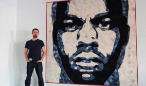 HIP TAKE: Artist Luke Haynes with one of his creations, a quilt featuring the faces of rappers Jay Z and Kanye West. (Brad Farwell www.bradfarwell.com)