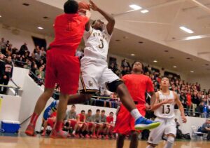 MAKING A GO OF IT: Santa Monica High School's Mikhail Brown attempts a shot against Beverly Hills on Friday at home. Beverly Hills walked away with the win, 58-45, and seized control of first place in the Ocean League in the process.  (Morgan Genser editor@www.smdp.com)