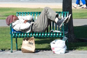 A homeless man sleeps on a bench in Palisades Park on Monday. A recent count has the number of homeless on the decline. (Paul Alvarez Jr. editor@www.smdp.com)