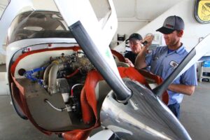 CLOSER LOOK: (L-R) Kim and Brian Davidson inspect a plane at their repair shop at SMO. (Daniel Archuleta daniela@www.smdp.com)