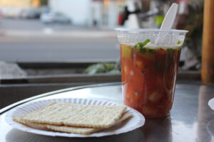 Served in a clear plastic Solo cup and accompanied with plain white crackers, the c√≥ctele is fully loaded with marinated shrimp and avocado. It's definitely no frills. (Michael Ryan michael@www.smdp.com)