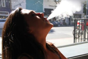 Brittany O'Boyle, an employee at FIX Vapor on Main Street, enjoys a mid-day vapor session. (Daniel Archuleta)