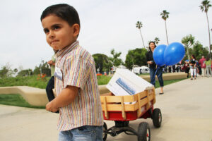 GOT ‘EM: A young boy helps the Residocracy group cart petitions to City Hall during a recent rally. (Daniel Archuleta daniela@www.smdp.com)