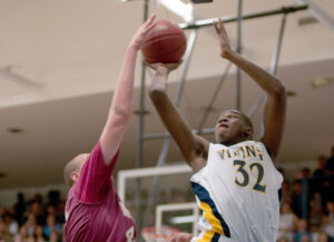 Samohi's Chris Smith (right) gets a shot over Mission Hills' Kameron Rooks on Tuesday. (Photo by Morgan Genser)