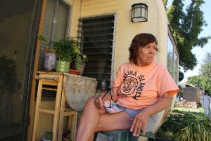 Village Trailer Park resident Frances Ward, 76, sits on the porch of her home. She has plans to move. (Daniel Archuleta daniela@www.smdp.com)