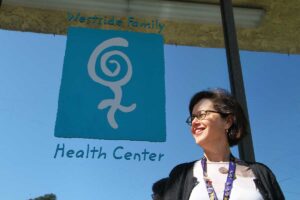 THE SPOT: Celia Bernstein, director of development at the Westside Family Health Center, stands in front of the clinic. (Daniel Archuleta daniela@www.smdp.com)