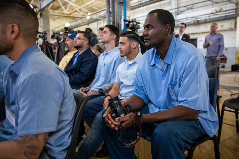 Inmate Gregory Eskridge (right) and others reporting for the San Quentin News attend Gov. Gavin Newsom's press event at San Quentin State Prison announcing the transformation of the facility to focus on training and rehabilitation on March 17, 2023. Photo by Martin do Nascimento, CalMatters