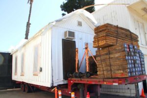 TIME FOR A RIDE: The historic Shotgun House is ready to roll to its new home. (Daniel Archuleta daniela@www.smdp.com)