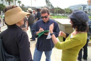 Daily Press Editor-in-Chief Kevin Herrera conducting interviews outside City Hall earlier this month. (Daniel Archuleta daniela@www.smdp.com)