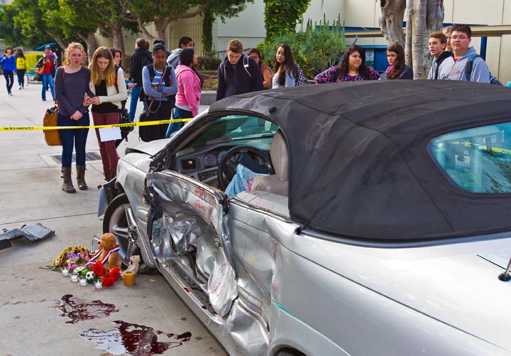 Samohi students view a simulated crash site and memorial staged on their campus, part of the In One Instant teen anti-distracted driving program held in March 2013 in preparation for National Distracted Driving Awareness Month in April. (Photo courtesy Eric Lawton)