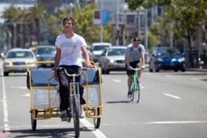 An pedicab driver bikes down the Embarcadero in San Francisco. (Photo courtesy Google Images)