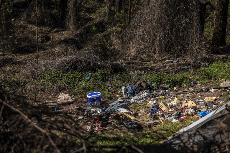 Debris from homeless encampments at a regional park lies scattered due to the recent flooding in Sacramento on April 11, 2023. Photo by Rahul Lal, CalMatters