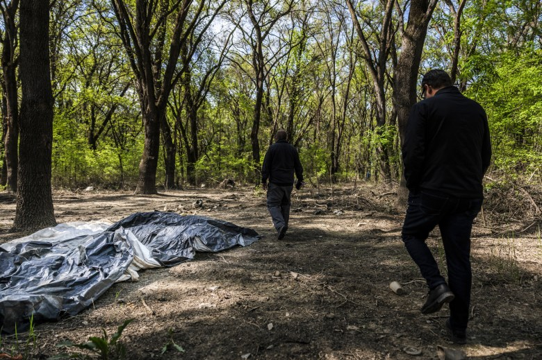 City homeless coordinators walk through a regional park in Sacramento where several homeless encampments are located on April 11, 2023. Photo by Rahul Lal for CalMatters