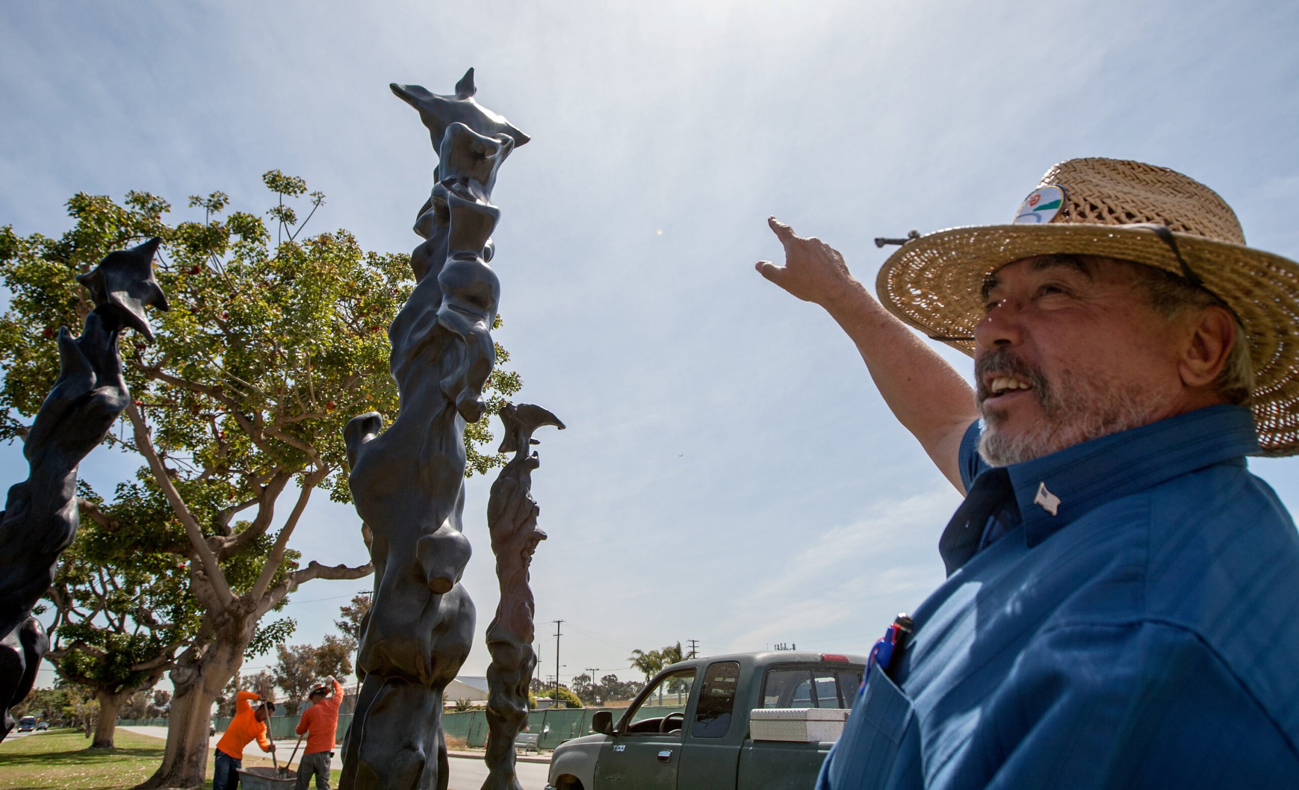 Public Works inspector Ramon Gutierrez oversees the final stages of the installation of Herb Alpert's 'Black Totems' sculptures on Friday at the corner of Olympic Boulevard and 26th Street. Grammy-winning musician and artist Alpert drew his inspiration for the pieces from totem poles from indigenous tribes in the Pacific Northwest. (Michael Yanow editor@www.smdp.com)