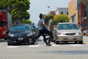 Pedestrians run across the crosswalk on Colorado Avenue and Second Street on Thursday afternoon. (Photo by Paul Alvarez Jr.)