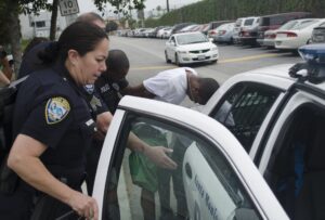 Santa Monica police place the suspect in Thursday's threat at SMC into a squad car. (Photo by Paul Alvarez Jr.)