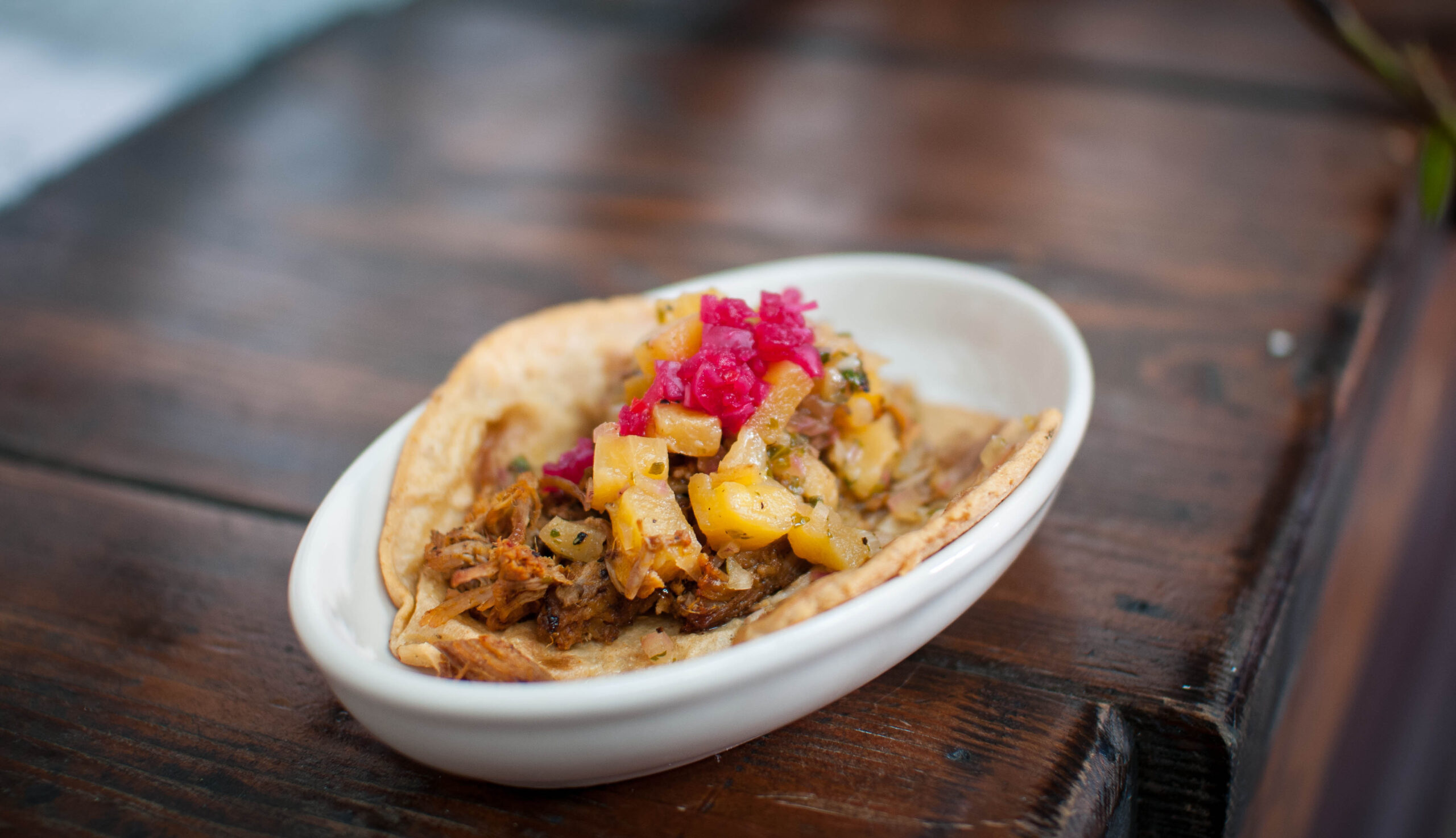 The al pastor taco with guajillo-rubbed and pineapple juice-marinated pork with grilled pineapple lime salsa. (Photo courtesy Tinga)