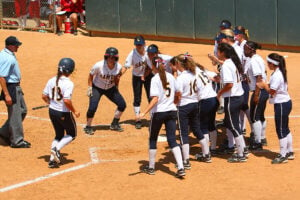 COMING HOME: Samohi's softball team awaits Sara Garcia at home plate after she hit a home run in the CIF-Southern Section Division 4 final. (Photo by Wendy Perl)