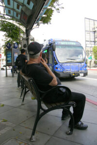 A man waits for a Big Blue Bus at the corner of Broadway and Fourth Street on Monday. (Photo by Daniel Archuleta)