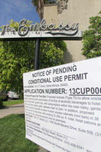 A notice regarding a pending conditional use permit is displayed in front of Palihouse. (Photo by Daniel Archuleta)