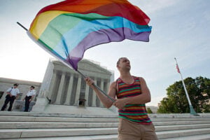 Gay rights advocate Vin Testa in front of the Supreme Court in Washington, Wednesday. Justices issued two major rulings on gay marriage cases. (Associated Press)