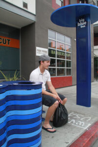 A man waits for a bus at one of the Big Blue Bus' new stops on Main Street on Tuesday. (Daniel Archuleta)