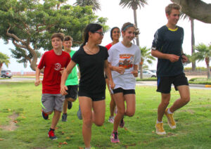 Justin Sardo (right) leads the Santa Monica Youth Running Club down the median on San Vicente Boulevard on Wednesday. (Daniel Archuleta daniela@www.smdp.com)