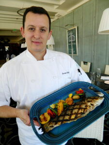 Sven Mede, executive chef at Catch in Casa del Mar beachfront hotel, with his grilled branzino and roasted vegetables. (Photo courtesy John Blanchette)