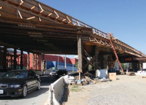 UNDER CONSTRUCTION: Drivers go underneath the future Exposition Light Rail Line near Cloverfield Boulevard. (File photo)