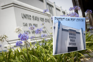 A group protesting the closure of the Fifth Street post office placed this sign in front of the building in June. (Brandon Wise brandonw@www.smdp.com)