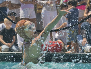 SPLISH SPLASH: Crowds of spectators watch the Cirque Du Soleil O-Show synchronized swimming team on opening day of the Annenberg Community Beach House. (File photo)