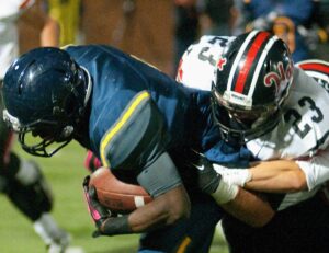 Samohi's Kwame Duggins is tackled by Hart's Joey Bilbon on Friday at Corsair Field during a 26-14 loss.  (Morgan Genser editor@www.smdp.com)