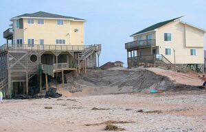 Concerted efforts to curb carbon emissions and eliminate dams on inland waterways are urgently needed, lest we keep spending millions of dollars on beach remediation projects thatonly have to be repeated over and over again in a losing battle. Pictured: Beach erosion at the Outer Banks, North Carolina. (Courtesy Soil Science at North Carolina State/Flickr)