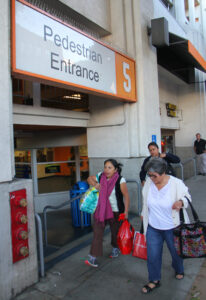 the spot: Big Blue Bus riders walk past the entrance to Parking Structure 5. (Daniel Archuleta daniela@www.smdp.com)