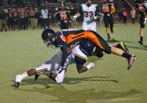 HEAD OVER HEELS: Samohi's Will Taylor tackles Beverly Hills wide receiver Harry Green during last week's game. (Paul Alvarez Jr. editor@www.smdp.com)