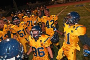 TEAM SPIRIT: Santa Monica High School players surround Matthew Tapia (center) after the Vikings defeated Inglewood, 21-0, at Corsair Field on Friday. Tapia, who has special needs, got into a game for the first time this season as the Vikings ran out the clock. (Morgan Genser editor@www.smdp.com)