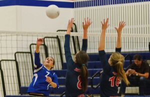 MAKING THE PLAY: Pacifica Christian's Maile Lane spikes the ball past two Brentwood defenders earlier this season. (File photo)