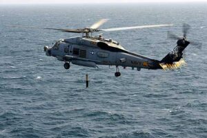 Environmentalists and animal advocates contend that Navy sonar testing in the ocean is harming whales and other marine wildlife and are calling on the Navy to curtail such training and testing exercises accordingly. Pictured: A Navy helicopter lowers a sonar device into the ocean. (Photo courtesy Official U.S. Navy Imagery)