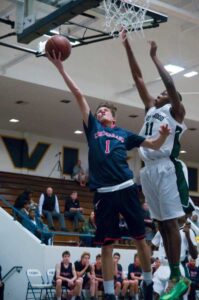 UP IT GOES: Crossroads' Max Pasamonte drives to the basket as Inglewood's Christopher Odionu tries to swat the ball on Wednesday at Santa Monica High. Inglewood went on to win. (Morgan Genser editor@www.smdp.com)