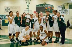 CHEERS: St. Monica's girls' basketball team celebrates after winning their Winter Classic tournament last week. (Paul Alvarez Jr. editor@www.smdp.com)