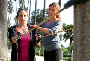 Lisa Foux (Left) works out with trainer Lily Moler (Right) in Palisades Park by the beach. (File photo)