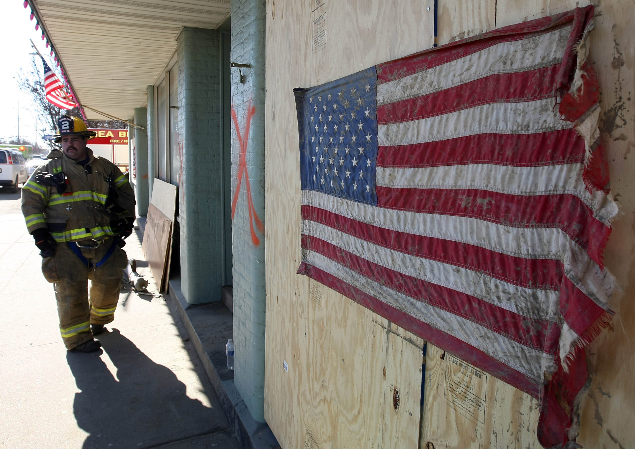 A fire fighter in New Jersey surveys the damage caused by Hurricane Sandy. (Photo courtesy Google Images)