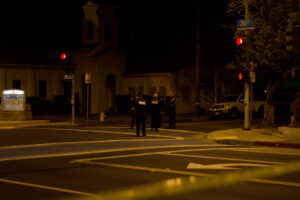 Police gather Tuesday night at the corner of Delaware Avenue and 20th Street, the site of a possible gang-related shooting in which a woman was shot in the shoulder. (Doug Olmedo editor@www.smdp.com)